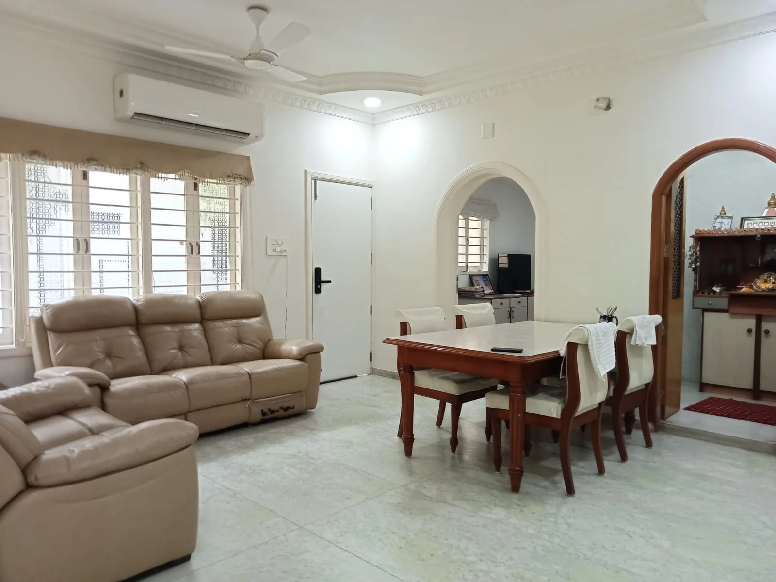 Furnished living and dining area with central air conditioning